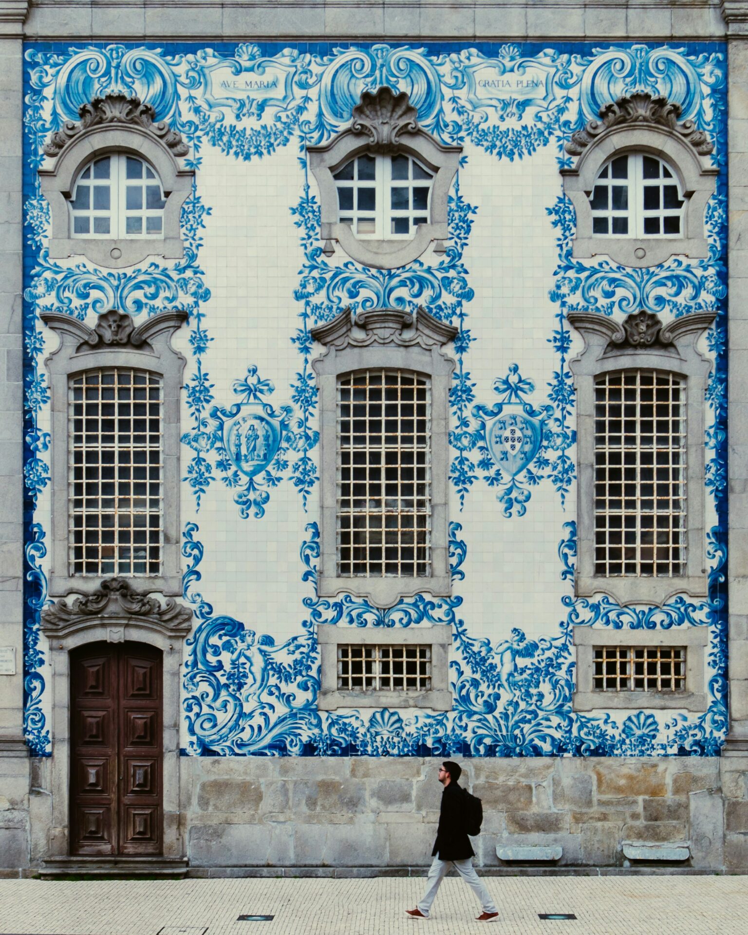 Facade of a restored palace in Lisbon with azulejos and wrought-iron balconies