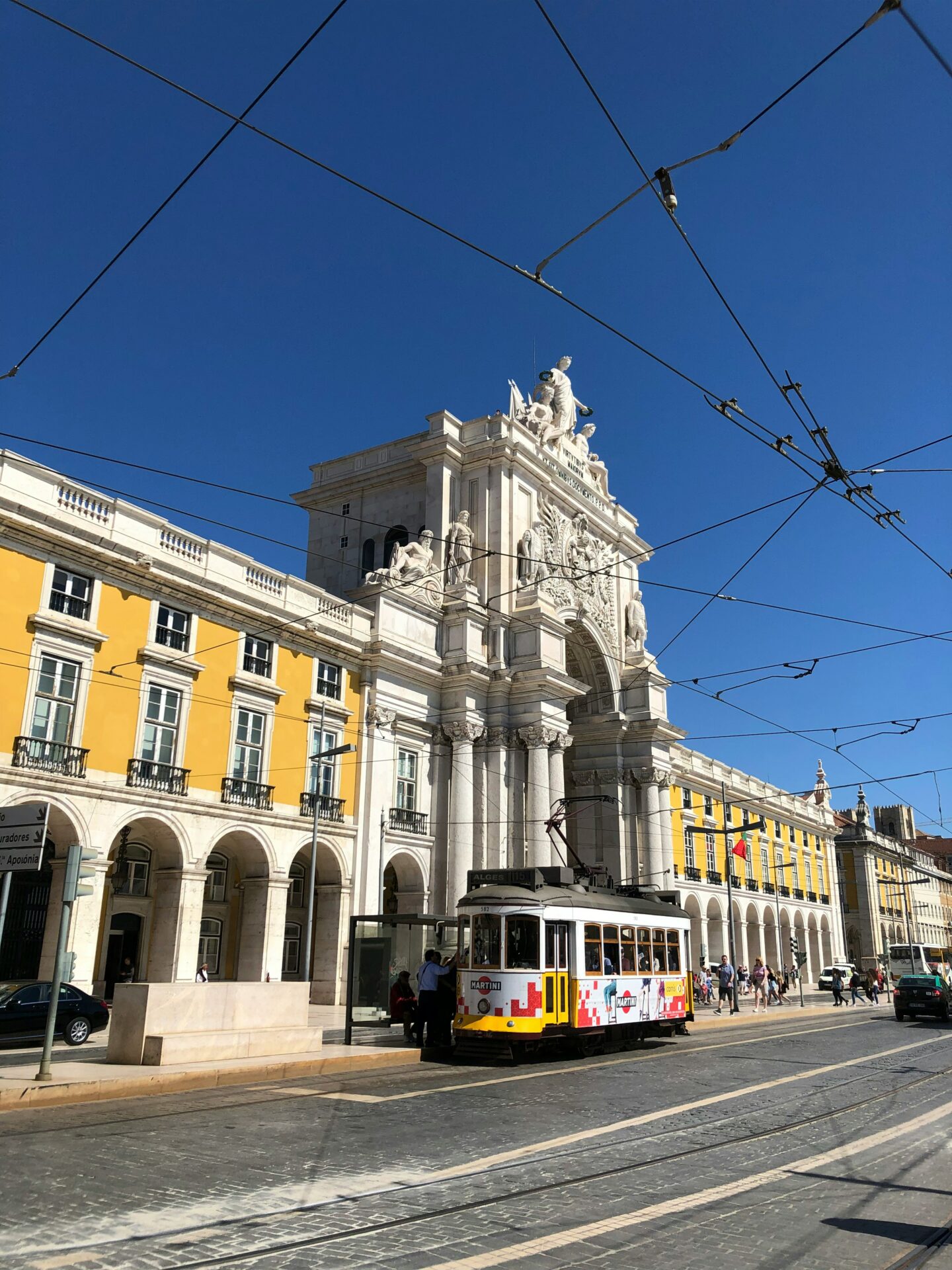 Historic Alfama street in Lisbon with colorful facades and tram